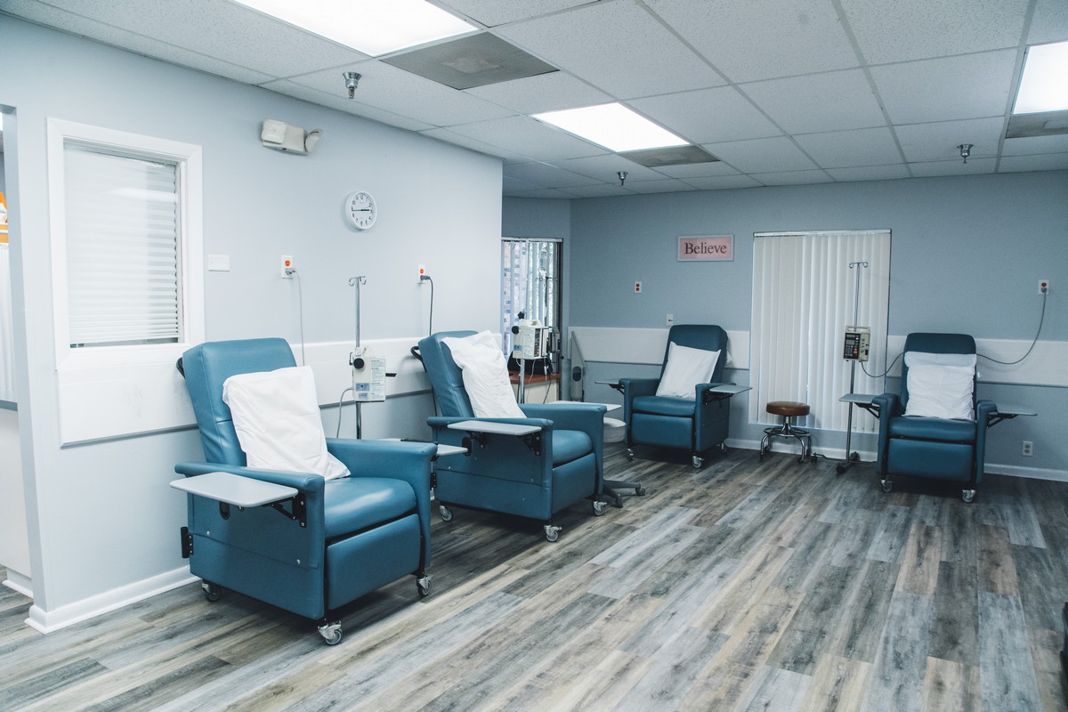 Empty infusion chairs lined up in a clean, modern treatment room.